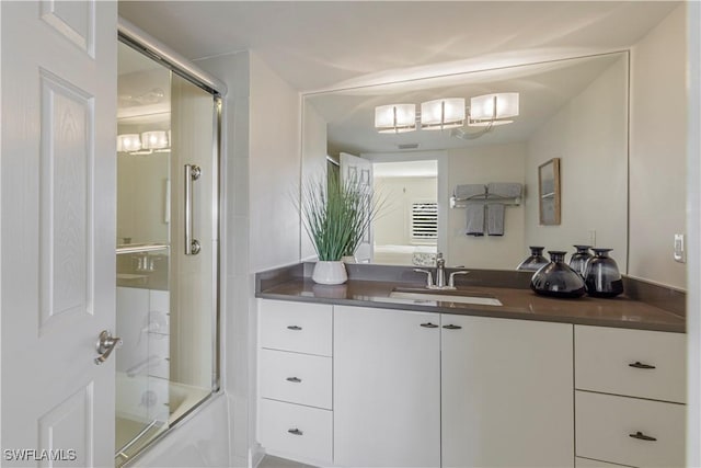 bathroom with vanity and bath / shower combo with glass door