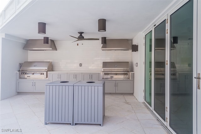 interior space with ceiling fan, an outdoor kitchen, and area for grilling