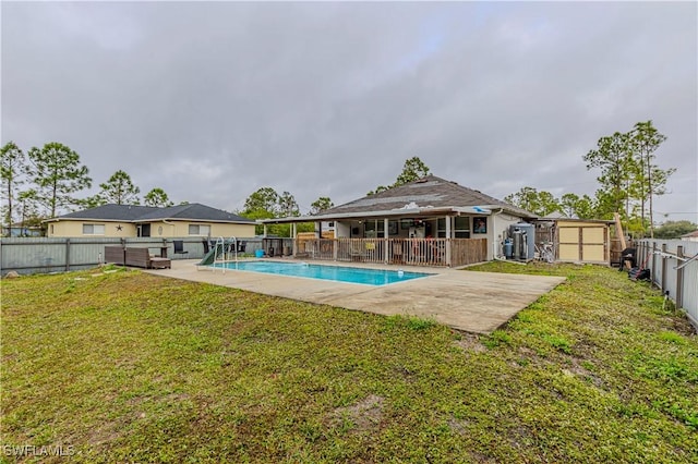 view of pool with a storage shed, a yard, and a patio