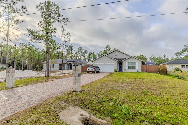 view of front of property featuring a front yard, solar panels, and a garage