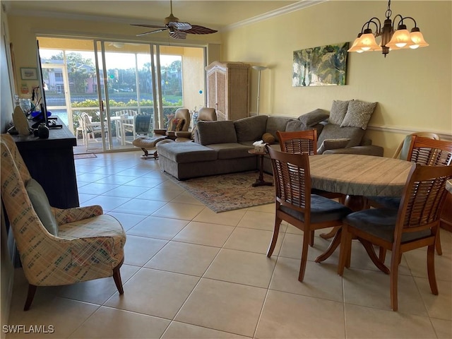 tiled dining room featuring crown molding and ceiling fan with notable chandelier