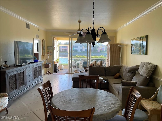 tiled dining space with crown molding and ceiling fan with notable chandelier