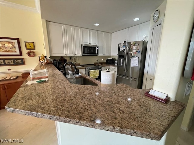 kitchen with white cabinets, appliances with stainless steel finishes, sink, kitchen peninsula, and light tile patterned floors