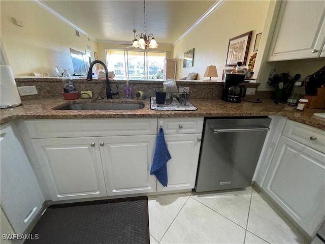 kitchen with sink, an inviting chandelier, and white cabinetry