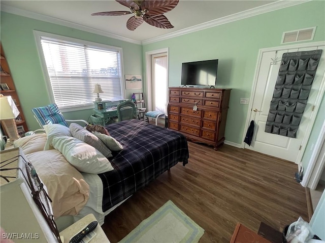 bedroom featuring ceiling fan, dark hardwood / wood-style flooring, and crown molding