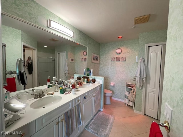 bathroom featuring walk in shower, vanity, tile patterned floors, and toilet