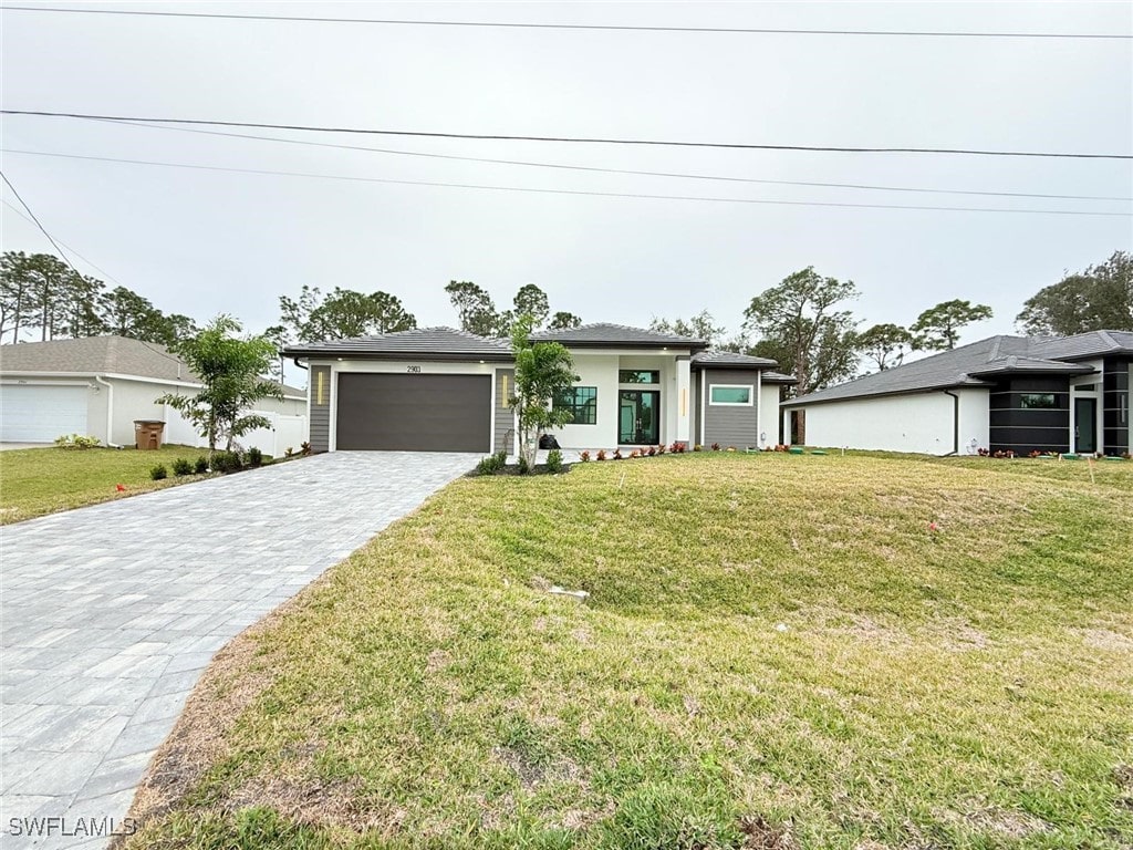 view of front of house with a garage and a front yard