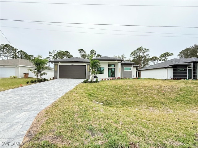 view of front of house with a garage and a front yard