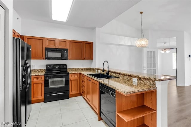 kitchen with black appliances, sink, hanging light fixtures, kitchen peninsula, and light stone counters