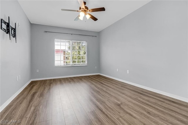 unfurnished room featuring hardwood / wood-style flooring and ceiling fan