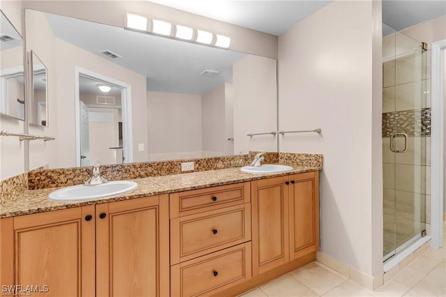 bathroom with walk in shower, tile patterned floors, and vanity