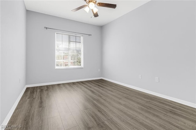 unfurnished room with ceiling fan and dark hardwood / wood-style flooring