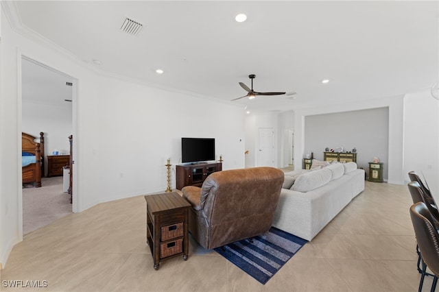 living room featuring light tile patterned floors, crown molding, and ceiling fan