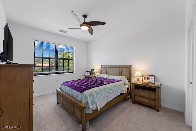 bedroom with ceiling fan and light carpet