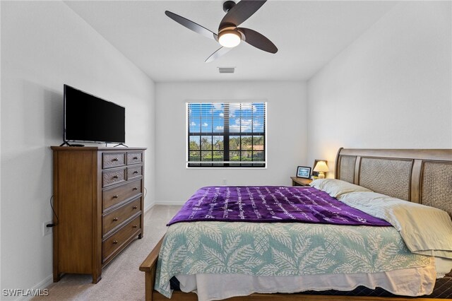 bedroom with light colored carpet and ceiling fan