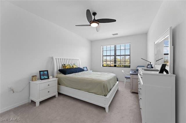 carpeted bedroom featuring multiple windows and ceiling fan