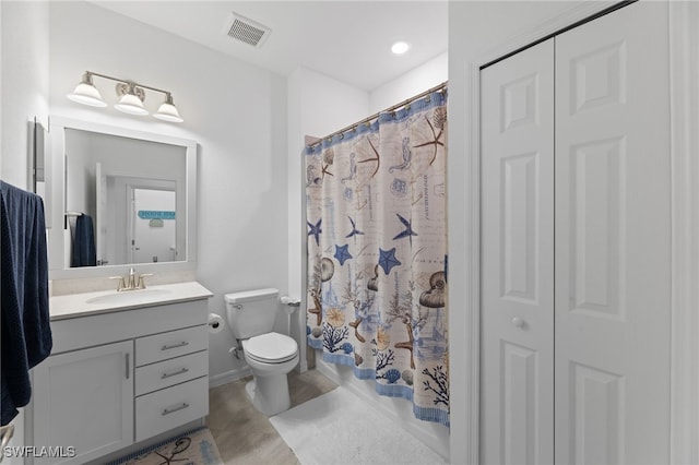 bathroom featuring vanity, toilet, and curtained shower