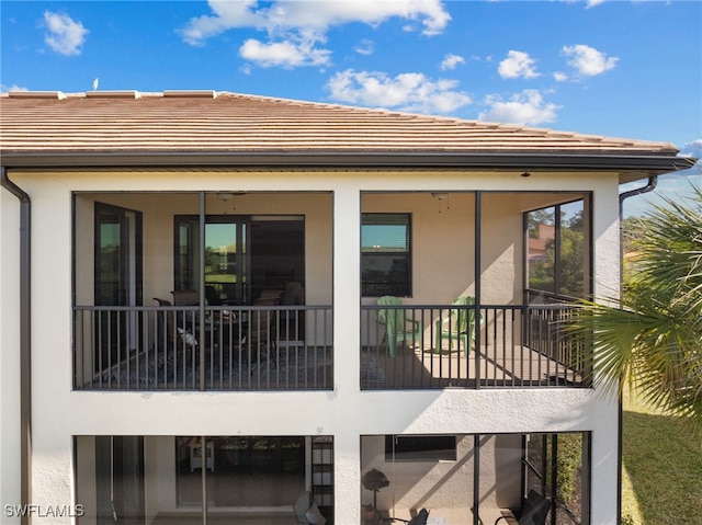 back of house featuring a balcony