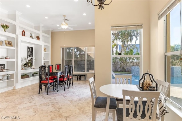 dining room featuring built in features and ceiling fan with notable chandelier