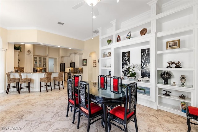 dining room with ceiling fan and built in features