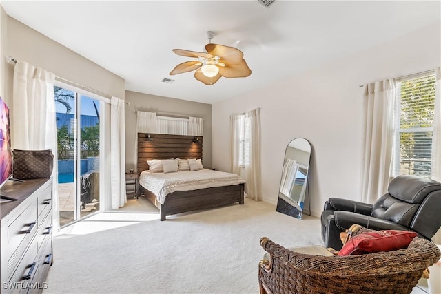 carpeted bedroom featuring ceiling fan and access to exterior