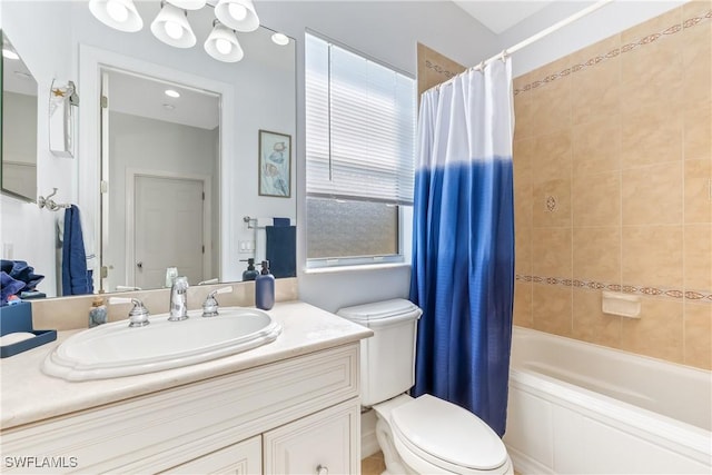 full bathroom featuring toilet, vanity, and shower / bathtub combination with curtain