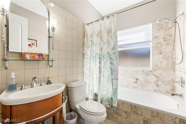 full bathroom featuring tile walls, toilet, vanity, and shower / bath combination with curtain