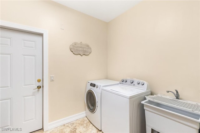 clothes washing area featuring washer and dryer and sink