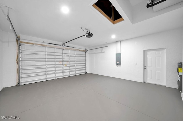 garage with a garage door opener and electric panel