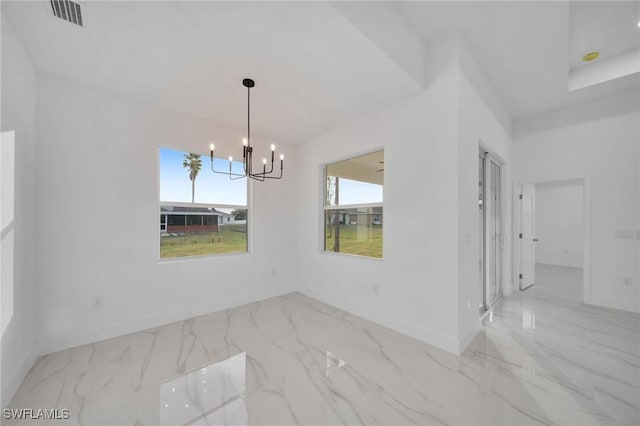 unfurnished dining area with a notable chandelier