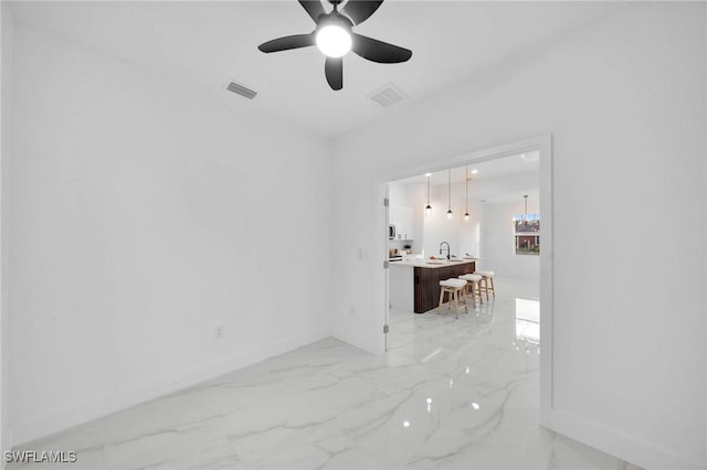 spare room with ceiling fan and sink