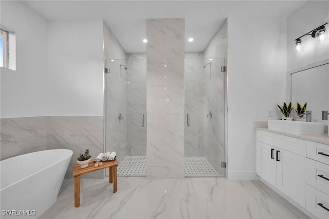 bathroom with vanity and independent shower and bath