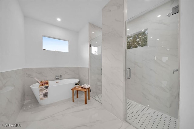 bathroom featuring separate shower and tub