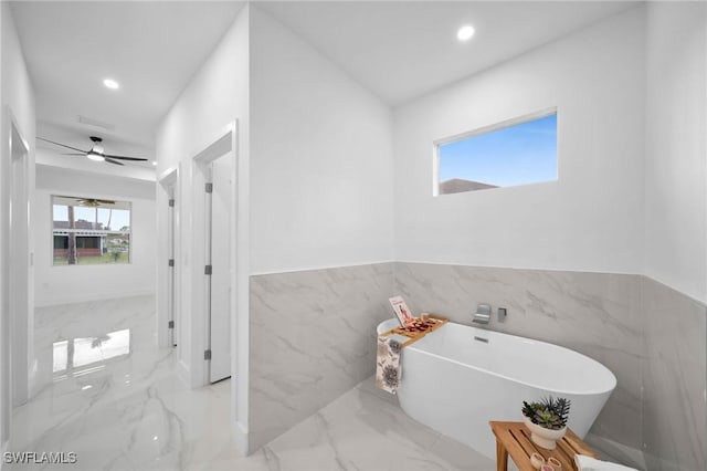 bathroom featuring tile walls and a bathtub