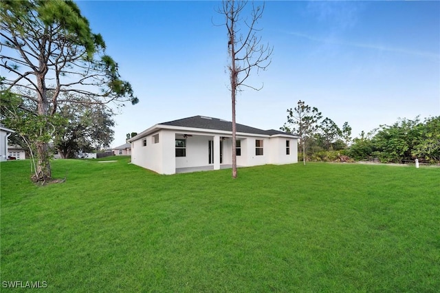 rear view of property featuring a yard