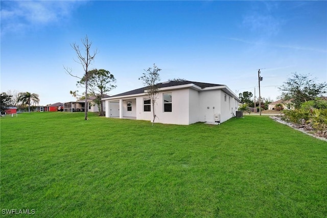 rear view of property with a lawn