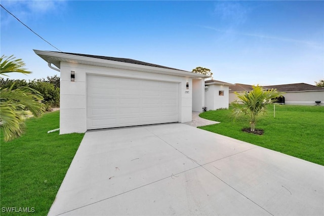 single story home featuring a garage and a front lawn