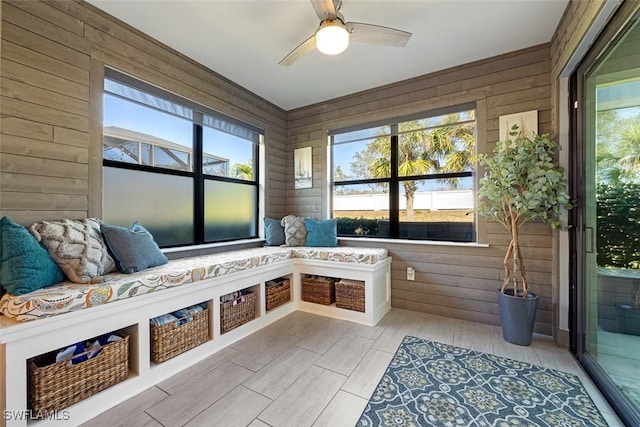 mudroom with wooden walls and ceiling fan