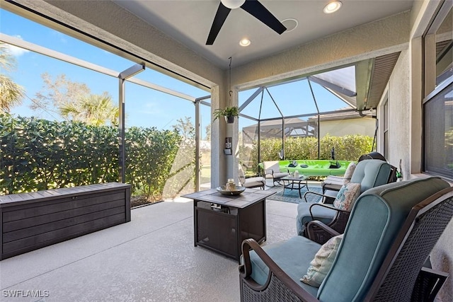 view of patio / terrace featuring ceiling fan, outdoor lounge area, and glass enclosure