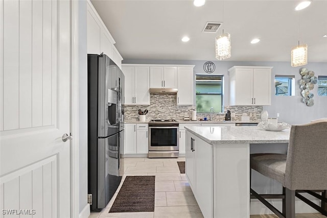 kitchen with white cabinets, hanging light fixtures, stainless steel range oven, and black fridge with ice dispenser