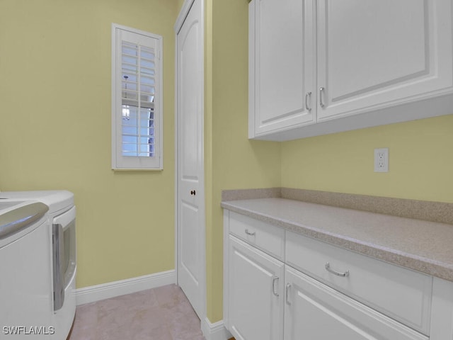 laundry area with cabinets and independent washer and dryer