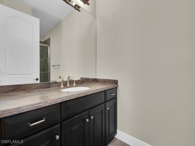 bathroom featuring vanity and a shower with door