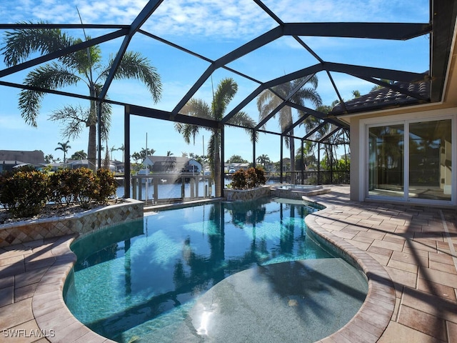 view of swimming pool with an in ground hot tub, a water view, glass enclosure, and a patio area