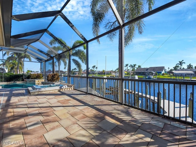 view of patio / terrace with a water view, a swimming pool with hot tub, and glass enclosure