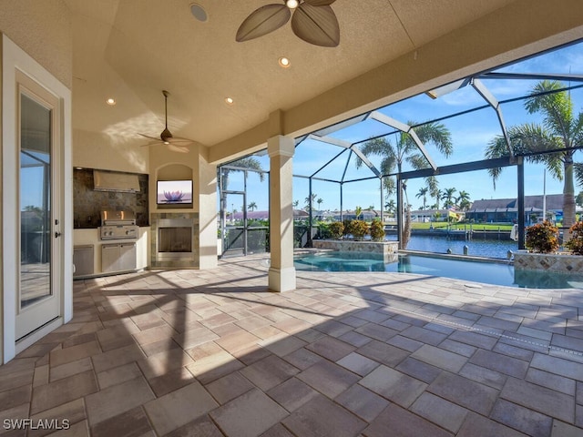 view of patio with pool water feature, an outdoor kitchen, grilling area, a lanai, and ceiling fan