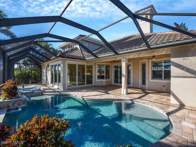 view of swimming pool featuring an in ground hot tub, ceiling fan, a lanai, and a patio area