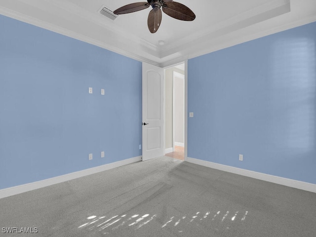 carpeted empty room with ceiling fan and ornamental molding