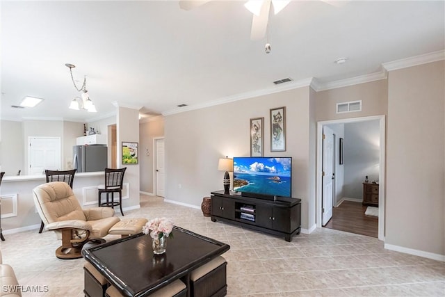 living room with ceiling fan with notable chandelier and crown molding