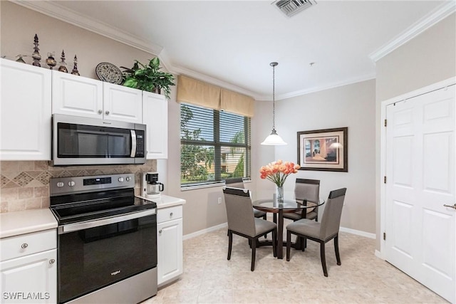 kitchen with appliances with stainless steel finishes, decorative backsplash, ornamental molding, pendant lighting, and white cabinets