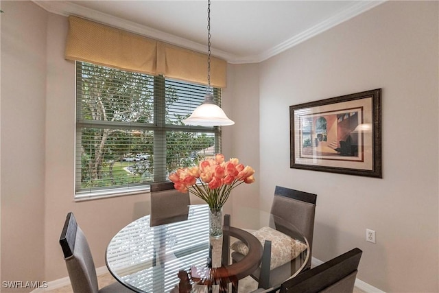 dining space featuring plenty of natural light and crown molding